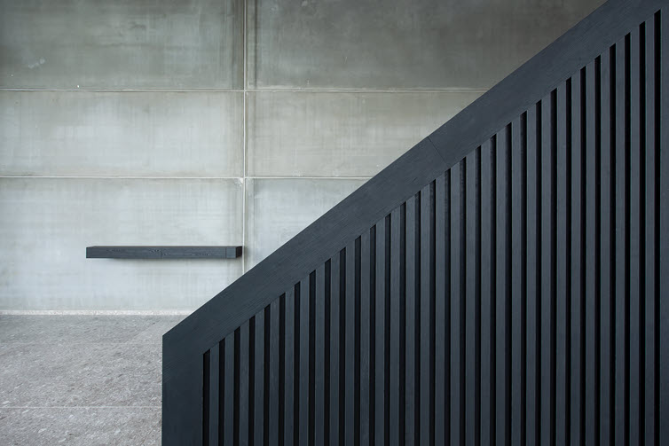 Black staircase in acoustic Master Oak slat panels 